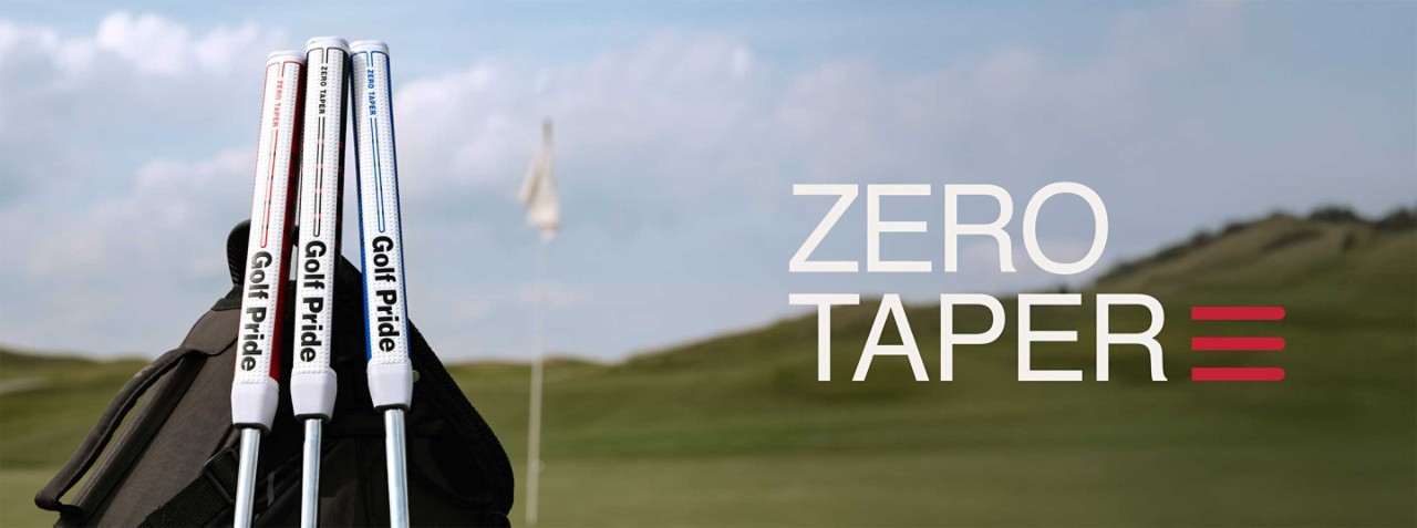 three zero taper golf clubs leaning against a golf bag on a gold green