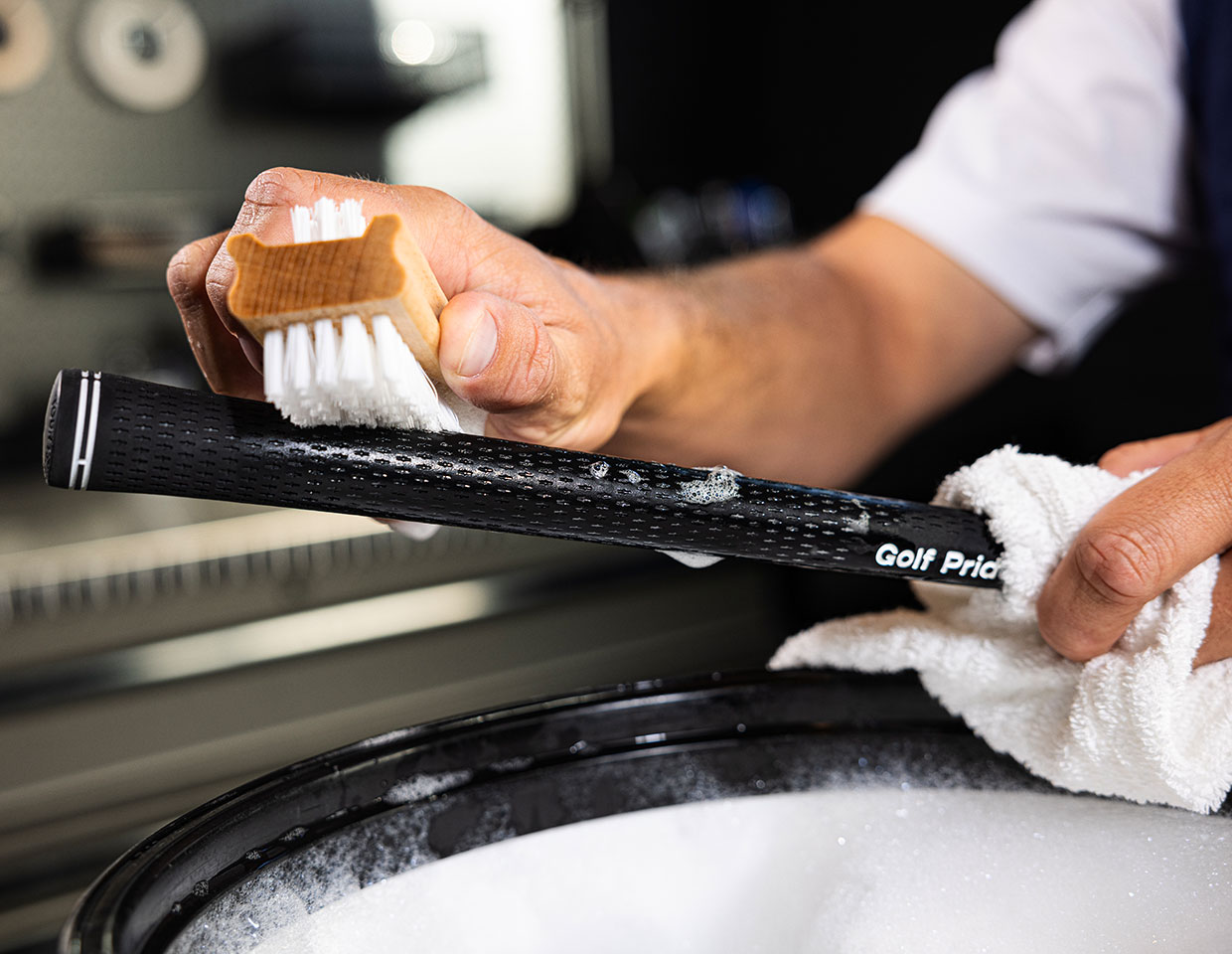 cleaning a grip with a brush, soap, and water