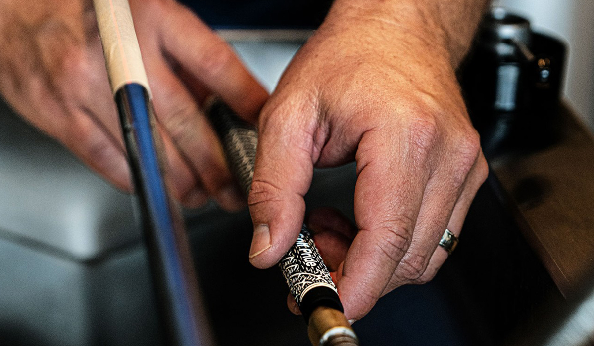Profession regripping a club with a golf pride grip