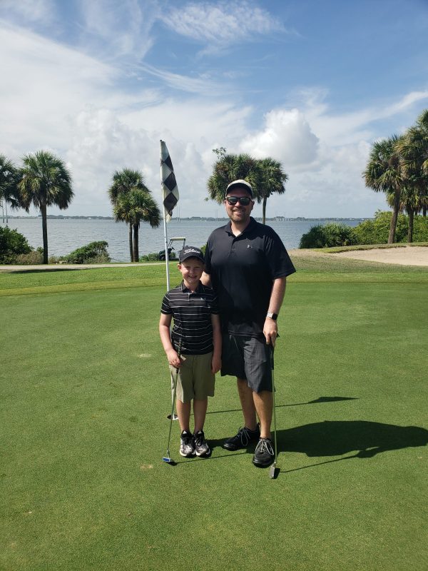 father and son on the golf course