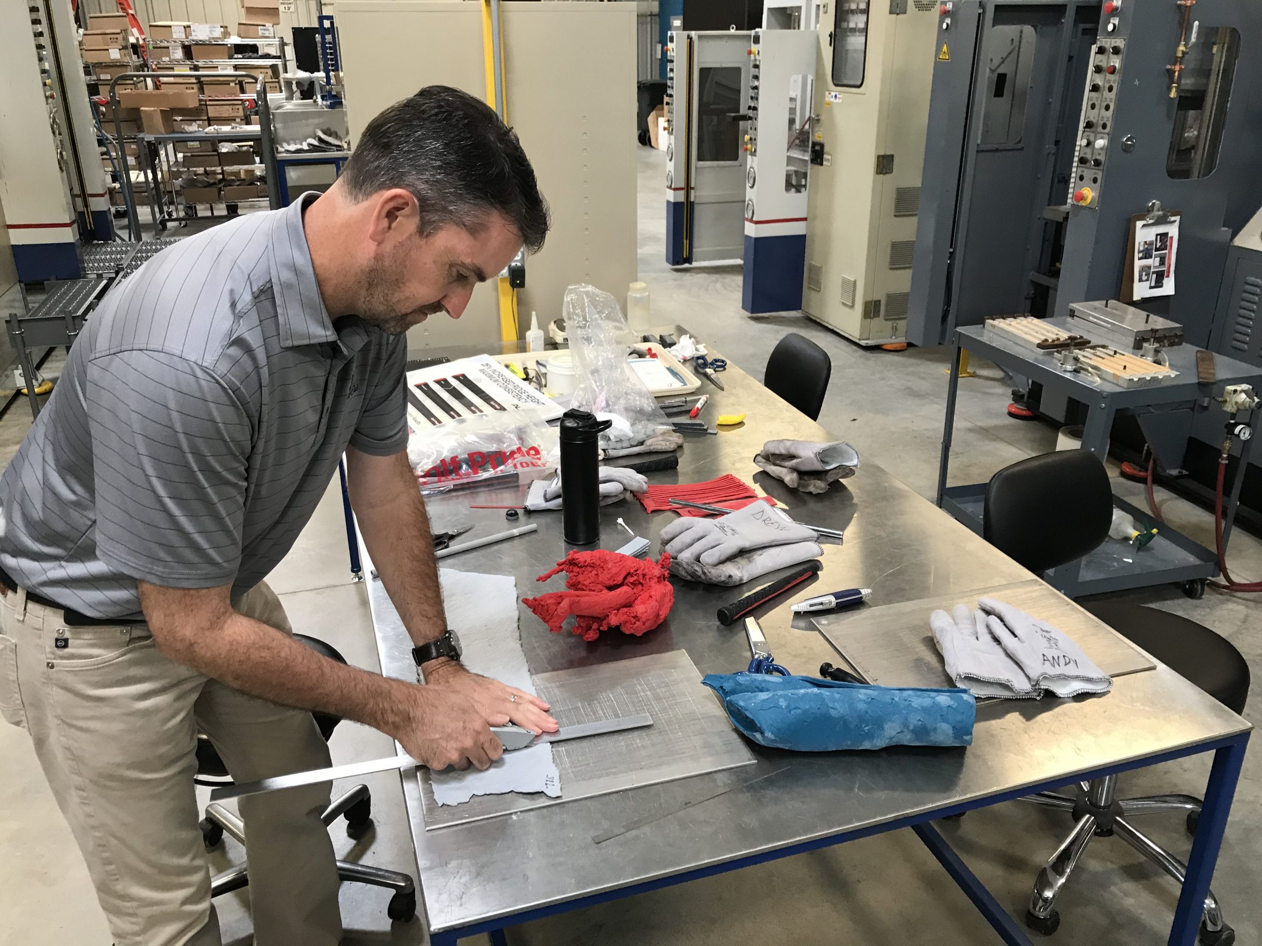 man works on grip with engineering equipment around him