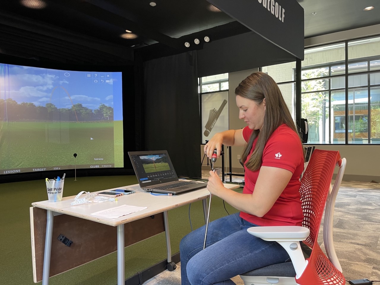 golf pride employee Sara Holland adjusting a club